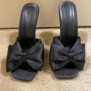 New, never worn black and gold heels.